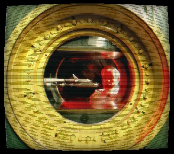 A spacecraft model seen through the porthole of a wind tunnel